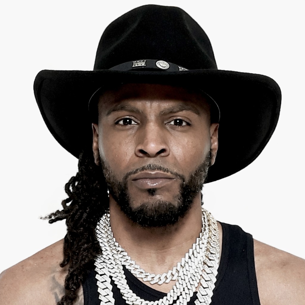 Juss Fresh in a black cowboy hat and layered chains